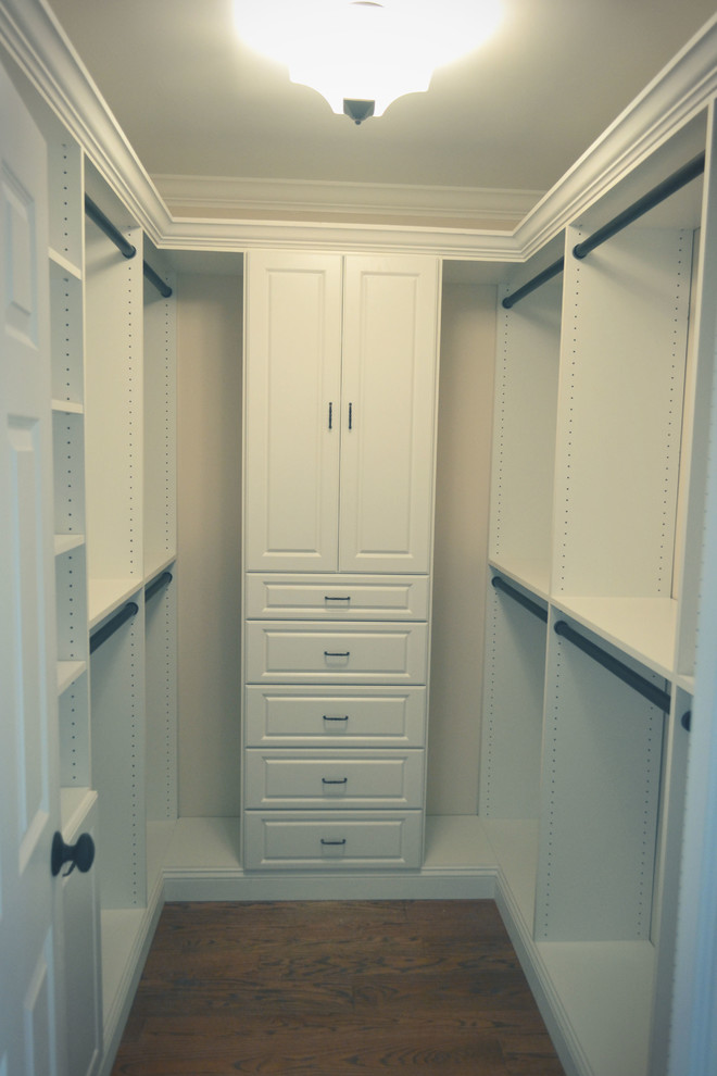 This is an example of a modern walk-in wardrobe in Philadelphia with raised-panel cabinets, white cabinets and medium hardwood floors.