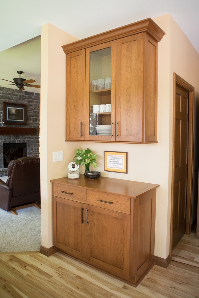 Large transitional l-shaped light wood floor eat-in kitchen photo in Cedar Rapids with a double-bowl sink, recessed-panel cabinets, medium tone wood cabinets, laminate countertops, multicolored backsplash, mosaic tile backsplash, white appliances and an island