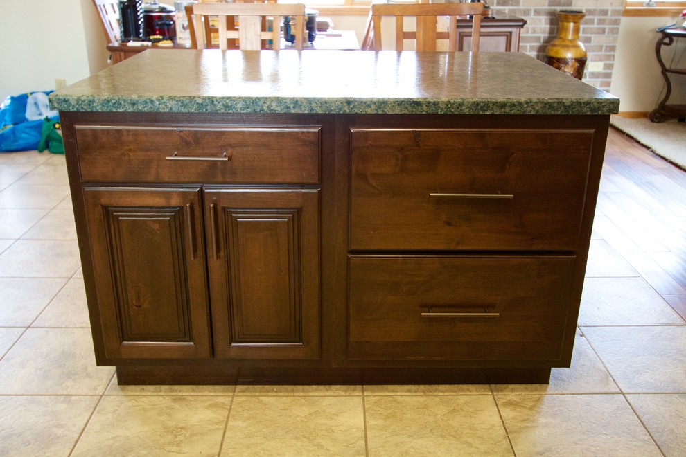 Inspiration for a mid-sized kitchen remodel with raised-panel cabinets, dark wood cabinets, laminate countertops and an island
