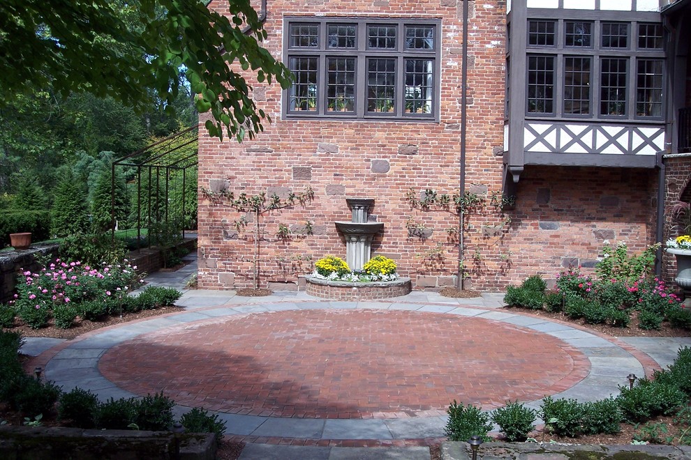 Inspiration for a large traditional backyard patio in Bridgeport with brick pavers and no cover.