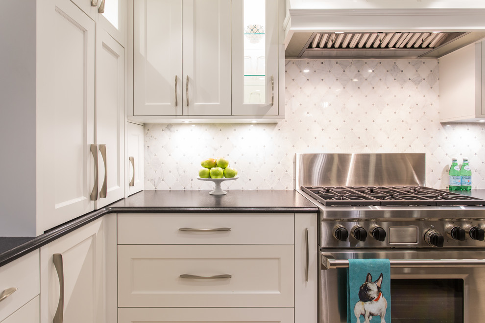 Inspiration for a large transitional l-shaped medium tone wood floor and beige floor eat-in kitchen remodel in Vancouver with an undermount sink, shaker cabinets, white cabinets, granite countertops, gray backsplash, marble backsplash, stainless steel appliances, an island and black countertops