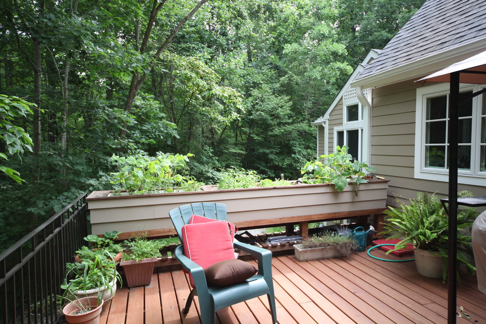 Mid-sized transitional backyard deck in Other with an awning.