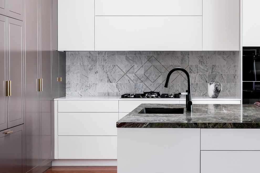 Mid-sized contemporary l-shaped eat-in kitchen in Sydney with an undermount sink, shaker cabinets, white cabinets, marble benchtops, grey splashback, marble splashback, black appliances, dark hardwood floors, with island and brown floor.