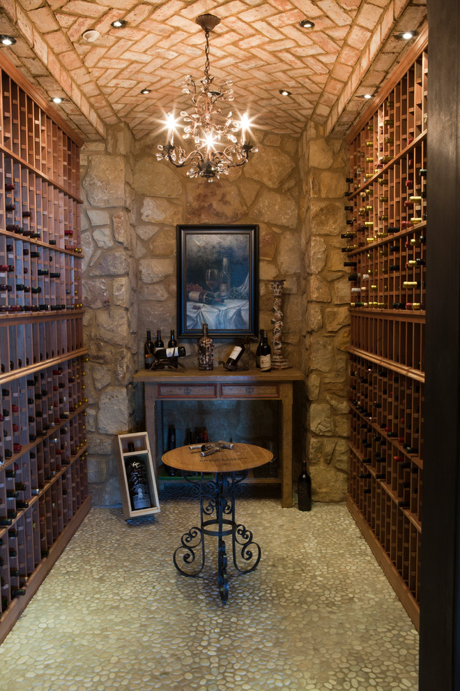 Inspiration for a mediterranean wine cellar in Dallas with storage racks.