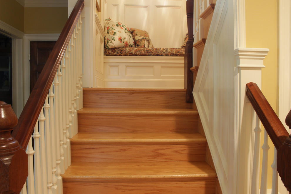 Inspiration for a mid-sized traditional wood u-shaped staircase in New York with wood risers and wood railing.