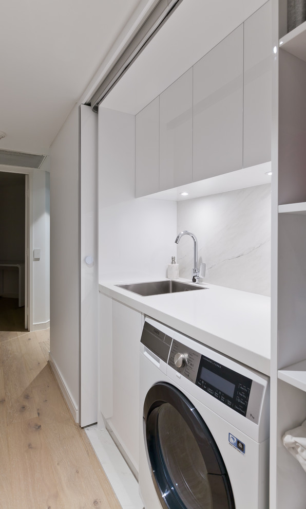 Design ideas for a small contemporary single-wall dedicated laundry room in Perth with an undermount sink, flat-panel cabinets, white cabinets, quartz benchtops, white walls and white benchtop.
