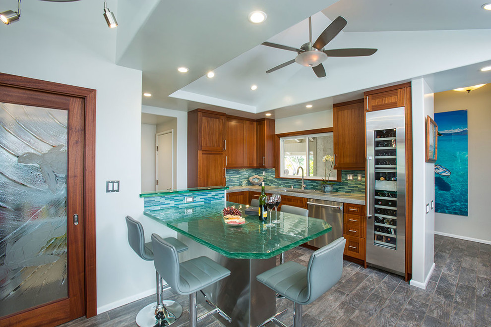 Design ideas for a large tropical eat-in kitchen in Hawaii with an undermount sink, shaker cabinets, medium wood cabinets, glass benchtops, glass tile splashback, stainless steel appliances, porcelain floors, no island and blue splashback.