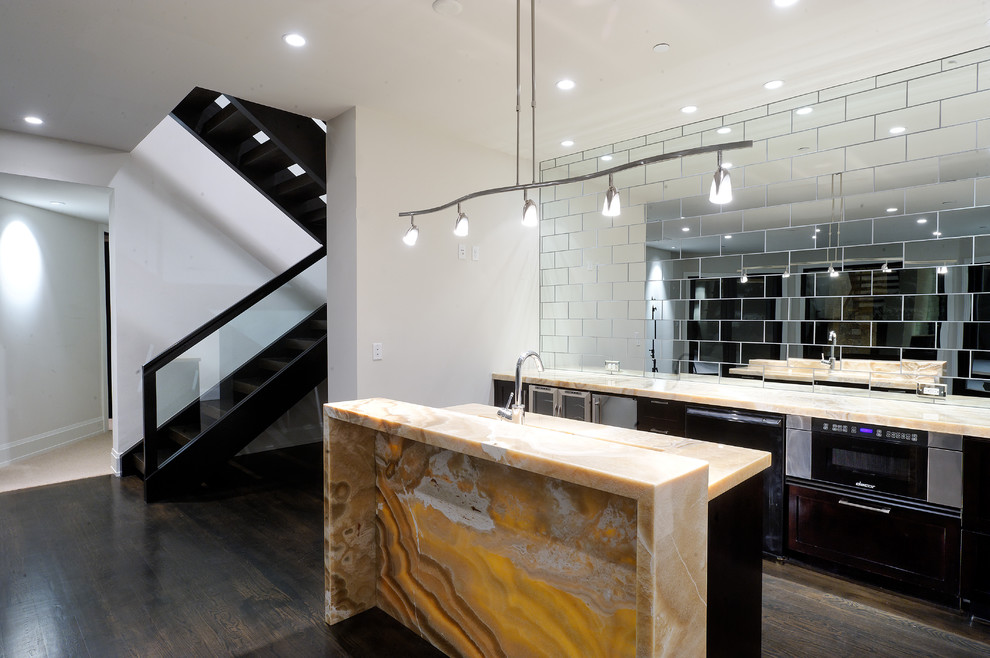 This is an example of a contemporary kitchen in Denver with mirror splashback and onyx benchtops.