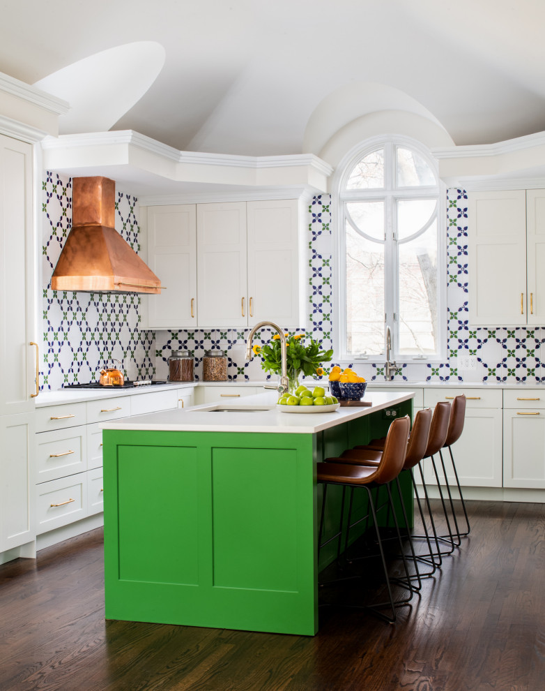 Large transitional u-shaped medium tone wood floor and brown floor kitchen photo in DC Metro with an undermount sink, shaker cabinets, white cabinets, multicolored backsplash, paneled appliances, an island and gray countertops