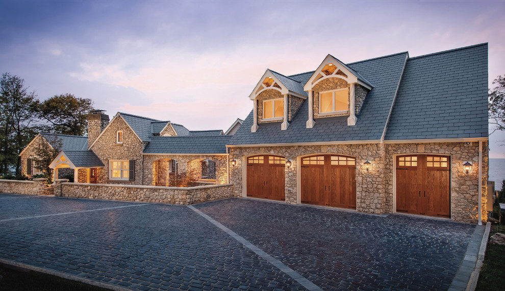 Example of a huge classic attached three-car garage design in Cincinnati