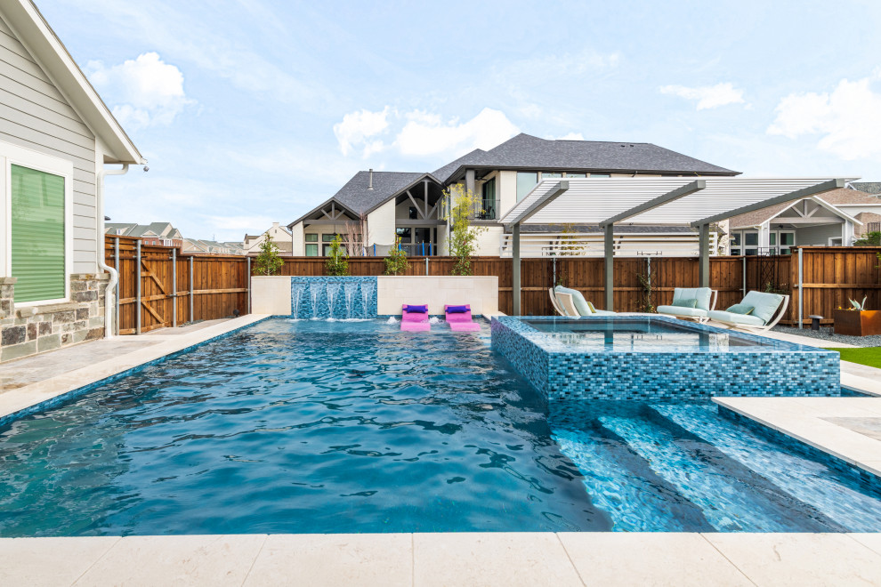 Inspiration for a mid-sized transitional backyard stone and custom-shaped pool remodel in Dallas