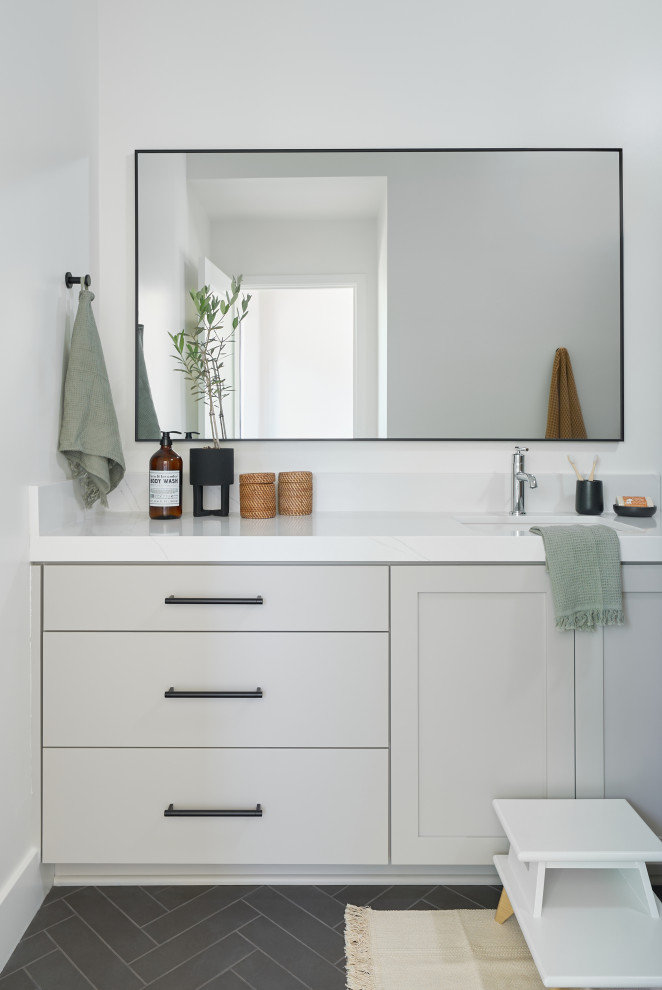 Inspiration for a mid-sized contemporary kids bathroom in Orange County with flat-panel cabinets, grey cabinets, an alcove shower, a two-piece toilet, white walls, porcelain floors, an undermount sink, engineered quartz benchtops, green floor, a sliding shower screen, white benchtops, a single vanity and a built-in vanity.