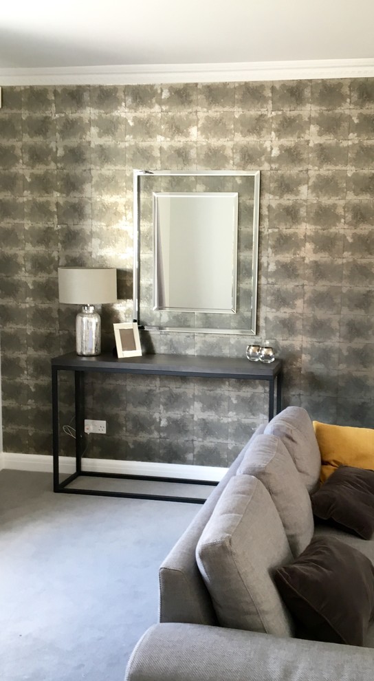 Inspiration for a medium sized contemporary enclosed living room in Surrey with grey walls and carpet.