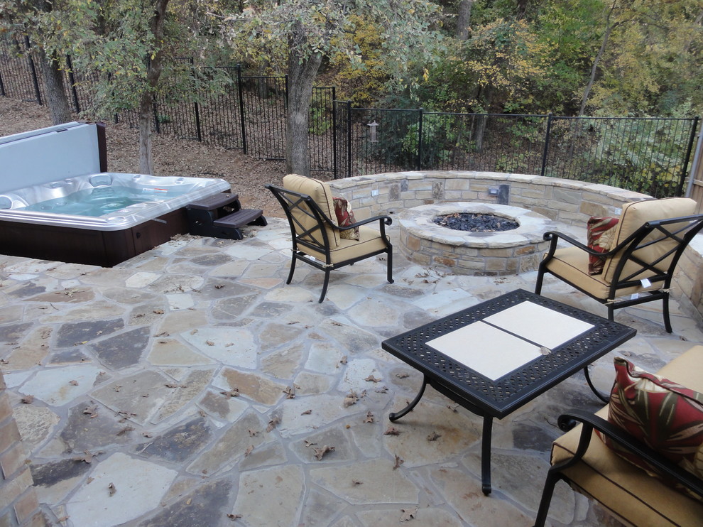 Photo of a mid-sized traditional backyard patio in Dallas with a fire feature, concrete pavers and no cover.