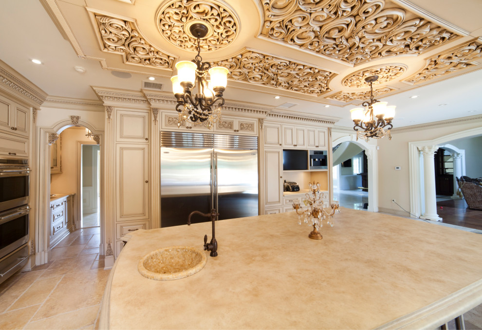 Enclosed kitchen - large traditional u-shaped beige floor and coffered ceiling enclosed kitchen idea in New York with a drop-in sink, shaker cabinets, beige cabinets, quartz countertops, brown backsplash, quartz backsplash, stainless steel appliances, an island and beige countertops