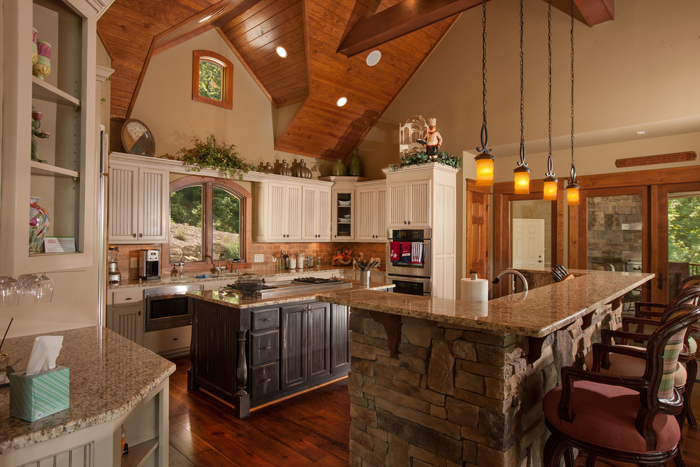Inspiration for a country u-shaped kitchen in Other with multiple islands, shaker cabinets, dark wood cabinets, brown splashback, stainless steel appliances and dark hardwood floors.