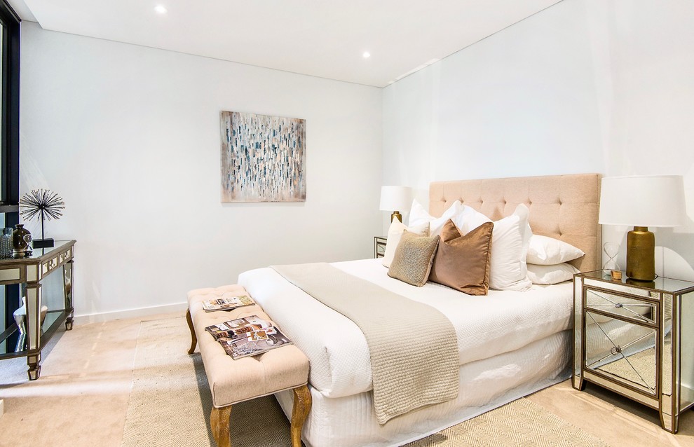 Photo of a small transitional guest bedroom in Sydney with white walls, limestone floors and beige floor.