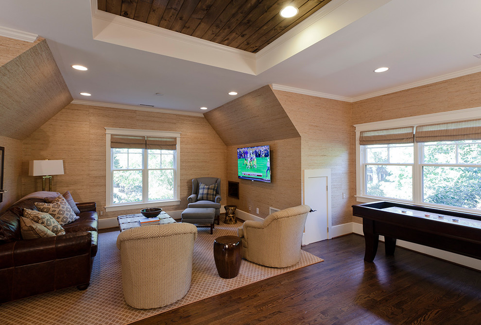 Photo of a traditional family room in Charlotte with beige walls, dark hardwood floors and a wall-mounted tv.
