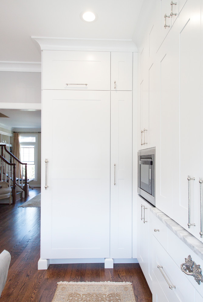 Eat-in kitchen - small transitional eat-in kitchen idea in DC Metro with white cabinets, marble countertops and paneled appliances
