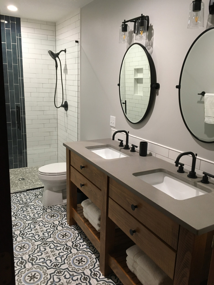 This is an example of a transitional bathroom in Kansas City with medium wood cabinets, grey benchtops and a freestanding vanity.