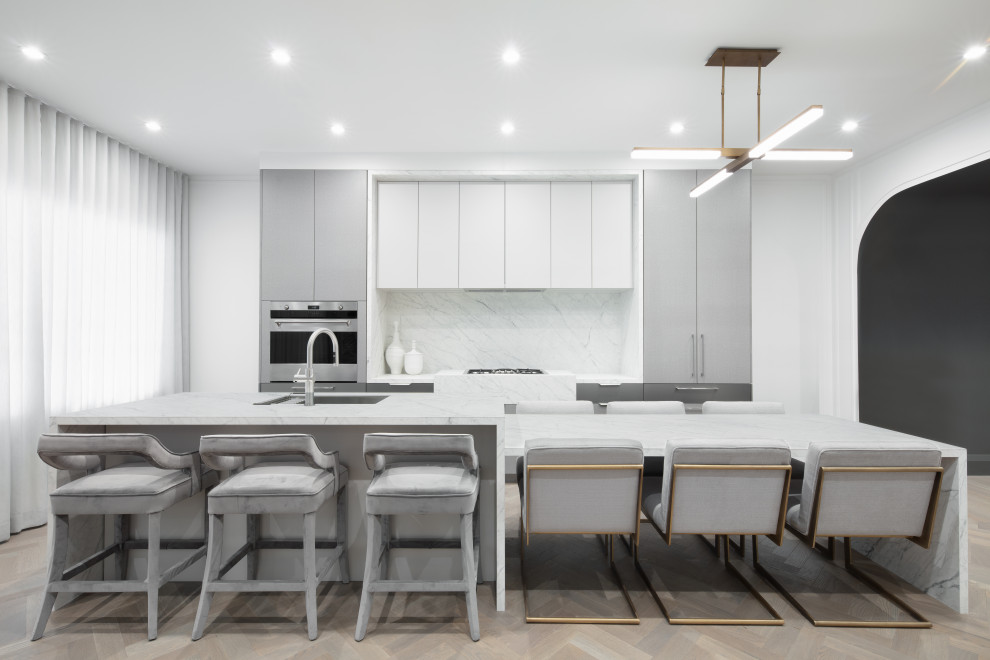 Example of a small eat-in kitchen design in Calgary with an undermount sink, flat-panel cabinets and quartz countertops