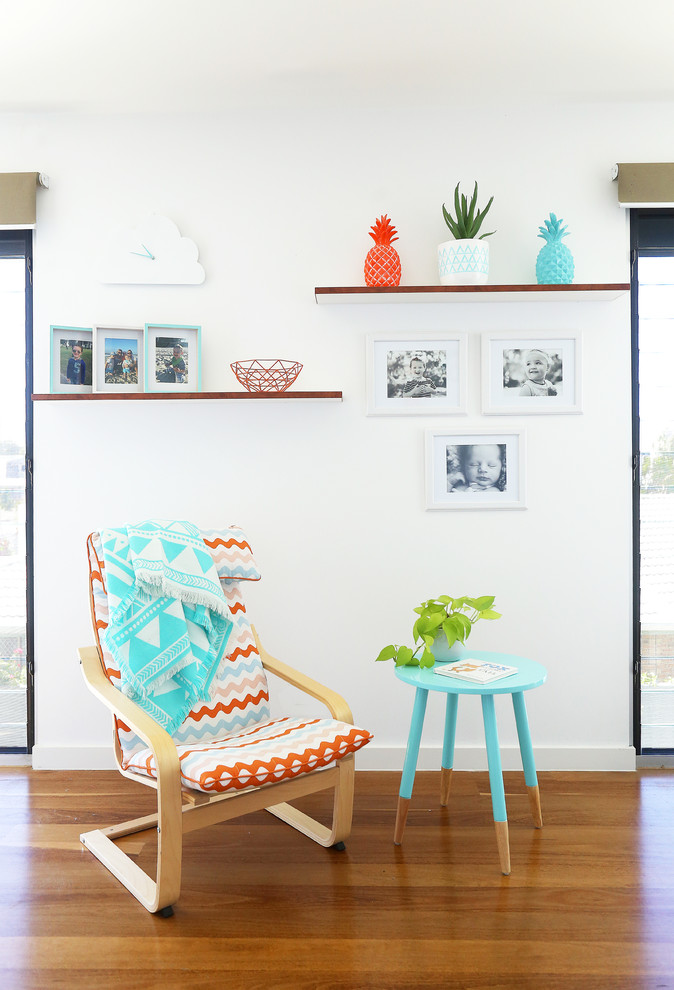 This is an example of a small contemporary gender-neutral kids' playroom for kids 4-10 years old in Gold Coast - Tweed with white walls and light hardwood floors.