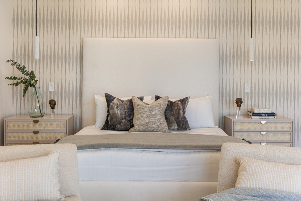 Large transitional master porcelain tile, beige floor and vaulted ceiling bedroom photo with beige walls, a standard fireplace and a stone fireplace
