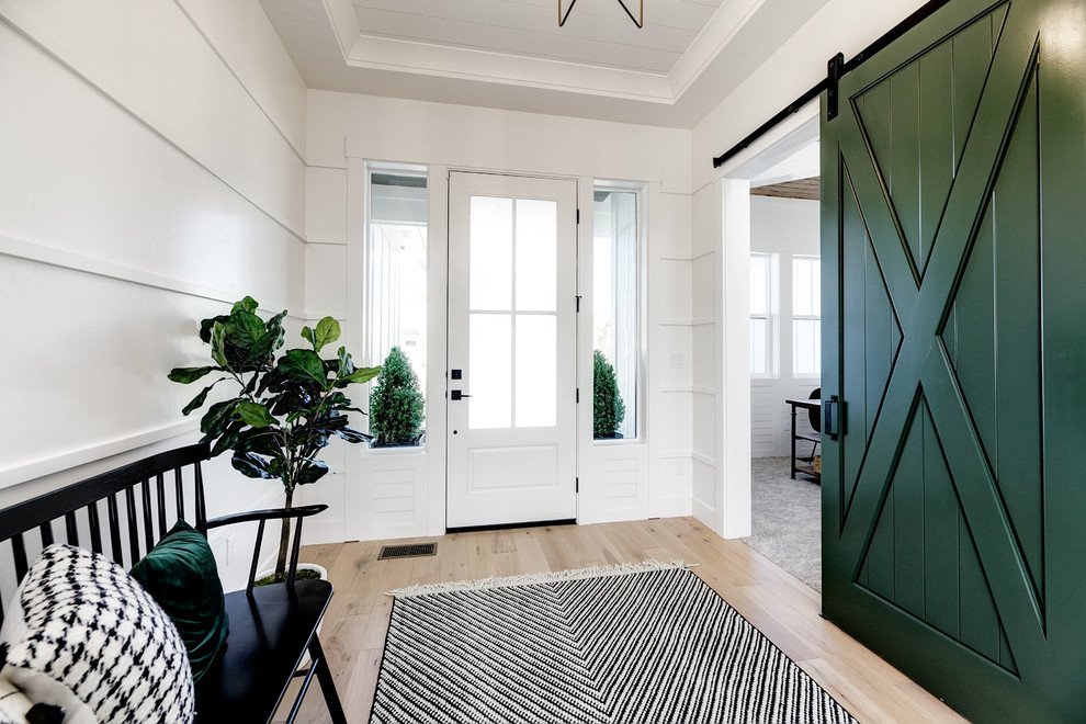 Inspiration for a mid-sized country foyer in Boise with white walls, light hardwood floors, a single front door, a white front door and beige floor.