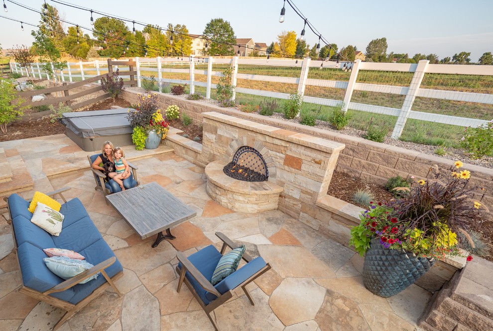 Mid-sized backyard patio in Other with a fire feature and natural stone pavers.