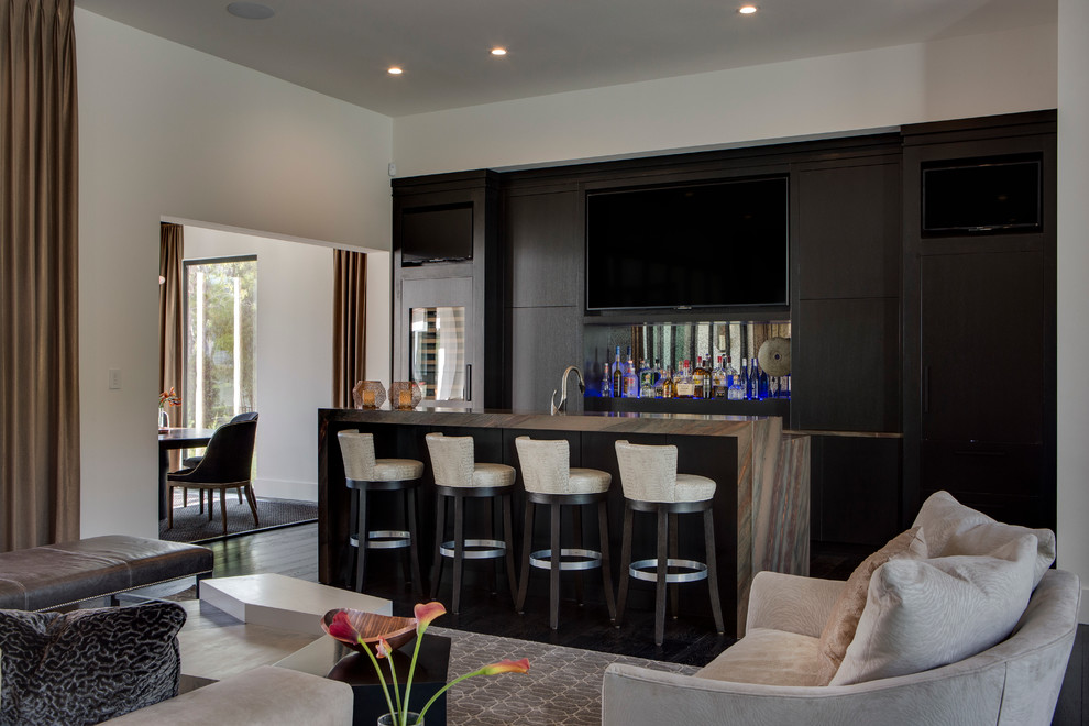 Photo of a contemporary galley seated home bar in Orlando with a drop-in sink, flat-panel cabinets, brown cabinets and dark hardwood floors.