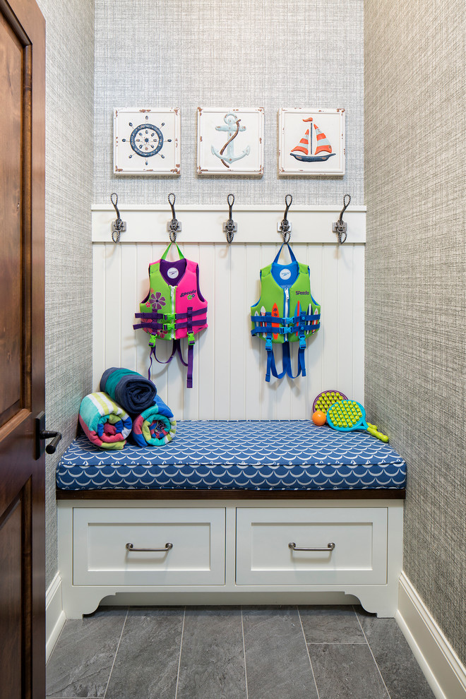 Photo of a small beach style mudroom in Minneapolis with grey walls, slate floors and grey floor.