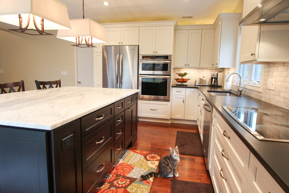 Mid-sized transitional l-shaped medium tone wood floor eat-in kitchen photo in Cincinnati with an undermount sink, recessed-panel cabinets, white cabinets, quartzite countertops, white backsplash, subway tile backsplash, stainless steel appliances and an island