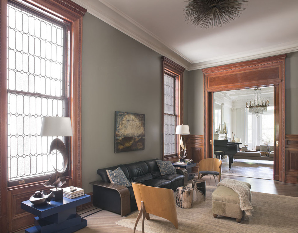 Inspiration for a transitional family room in New York with grey walls and medium hardwood floors.