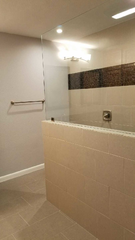 Mid-sized transitional master gray tile and porcelain tile porcelain tile doorless shower photo in Austin with raised-panel cabinets, a two-piece toilet, gray walls, an undermount sink and granite countertops