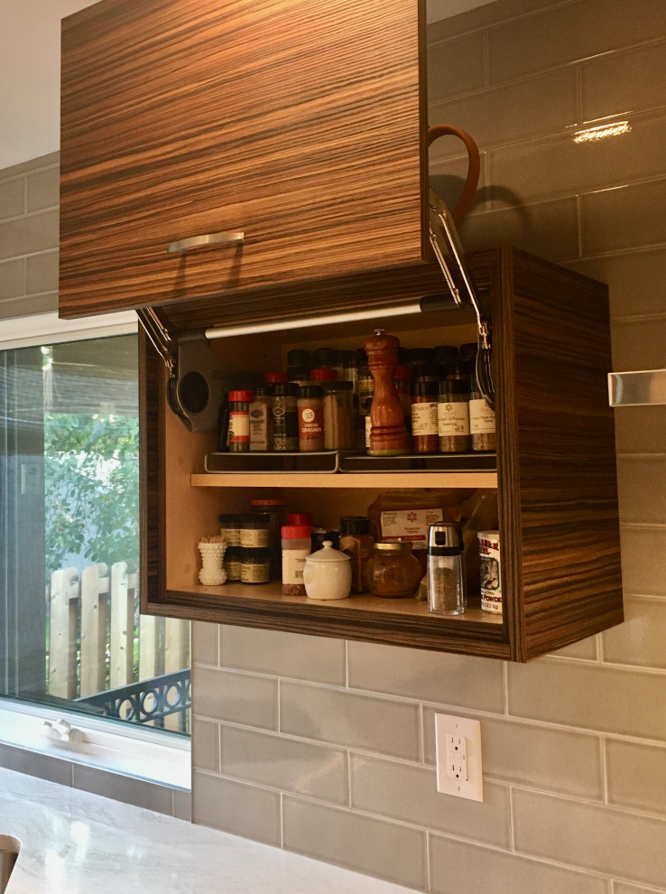 Enclosed kitchen - small transitional u-shaped medium tone wood floor and brown floor enclosed kitchen idea in Denver with a drop-in sink, shaker cabinets, white cabinets, quartz countertops, gray backsplash, subway tile backsplash, stainless steel appliances, a peninsula and white countertops