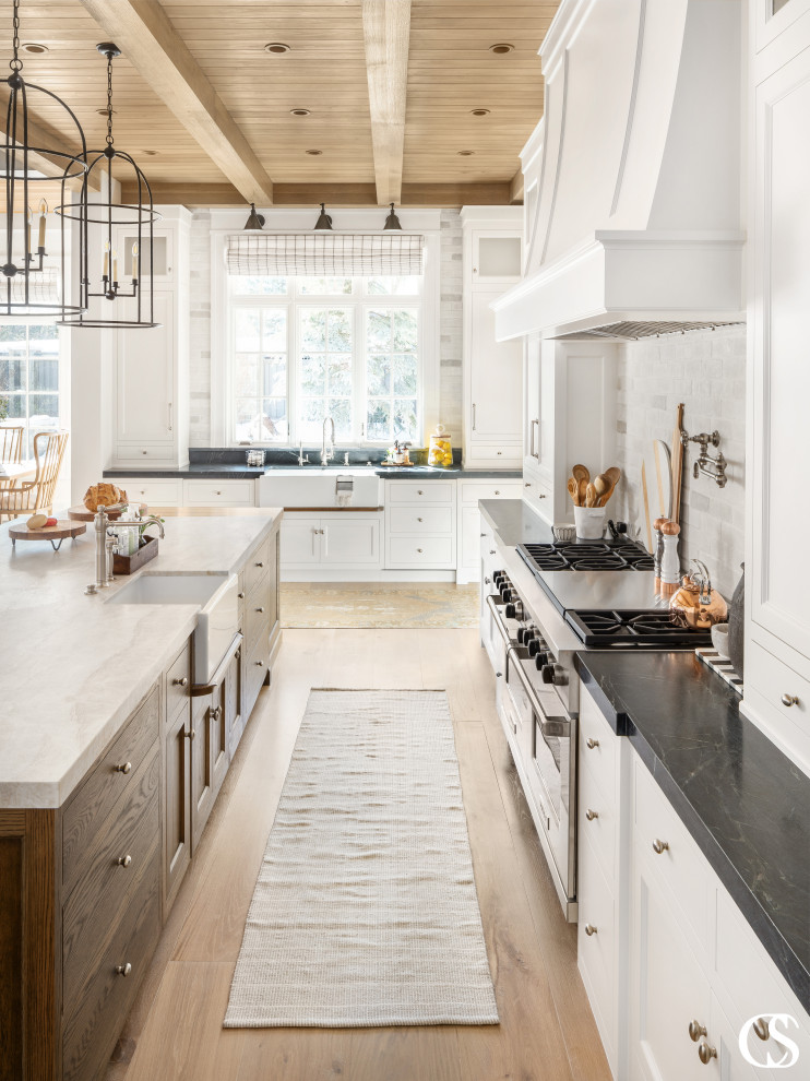 Inspiration for a large transitional open plan kitchen in Salt Lake City with shaker cabinets, white cabinets, soapstone benchtops, panelled appliances, medium hardwood floors, with island and wood.