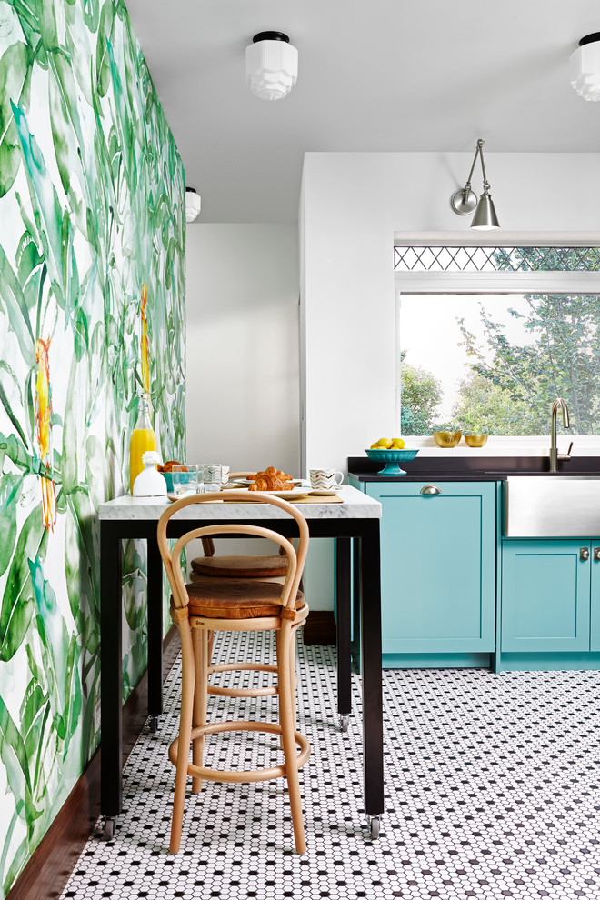 Design ideas for a tropical eat-in kitchen in Toronto with a farmhouse sink, shaker cabinets, blue cabinets, metal splashback and no island.