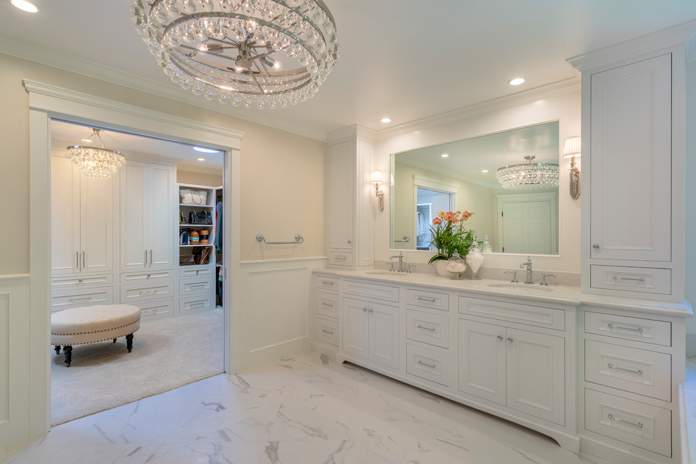 Design ideas for a large transitional master bathroom in Los Angeles with recessed-panel cabinets, white cabinets, a drop-in tub, a corner shower, white tile, ceramic tile, white walls, porcelain floors, an undermount sink, engineered quartz benchtops, multi-coloured floor and white benchtops.