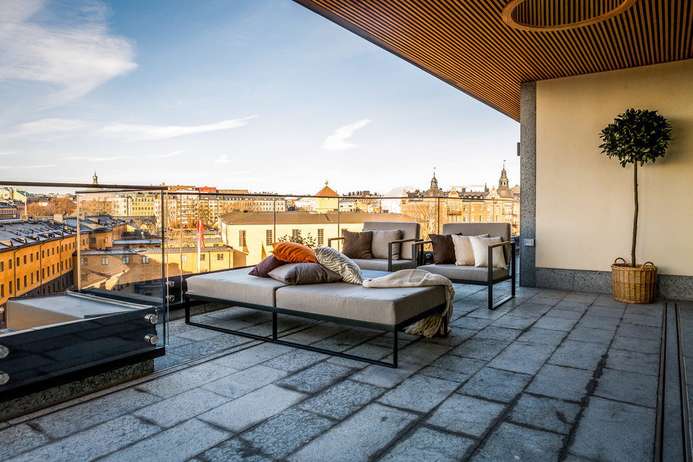 Photo of a contemporary balcony in Stockholm with a pergola.
