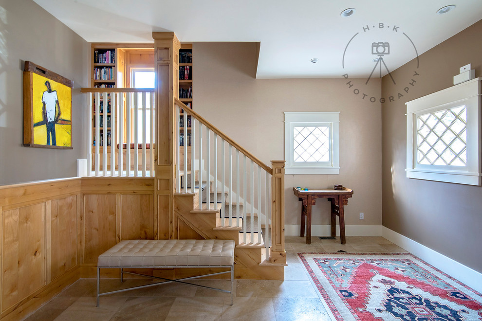 Large porcelain tile and brown floor foyer photo with brown walls