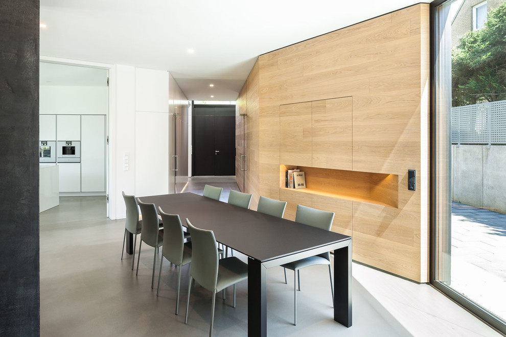 Photo of a large contemporary open plan dining in Cologne with white walls.