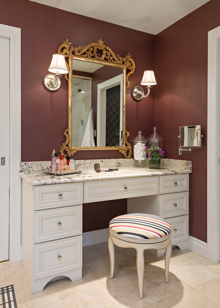 Photo of a large traditional master bathroom in St Louis with an undermount sink, furniture-like cabinets, beige cabinets, granite benchtops, a corner shower, a one-piece toilet, beige tile, stone tile, red walls and mosaic tile floors.