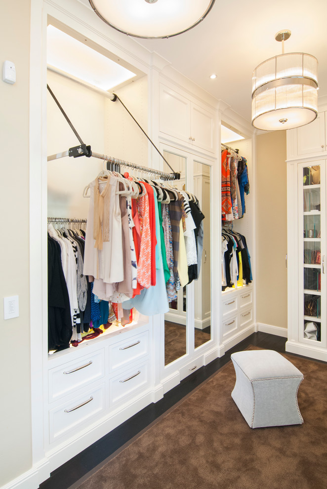 Photo of a traditional gender-neutral storage and wardrobe in San Francisco with open cabinets, white cabinets, dark hardwood floors and brown floor.