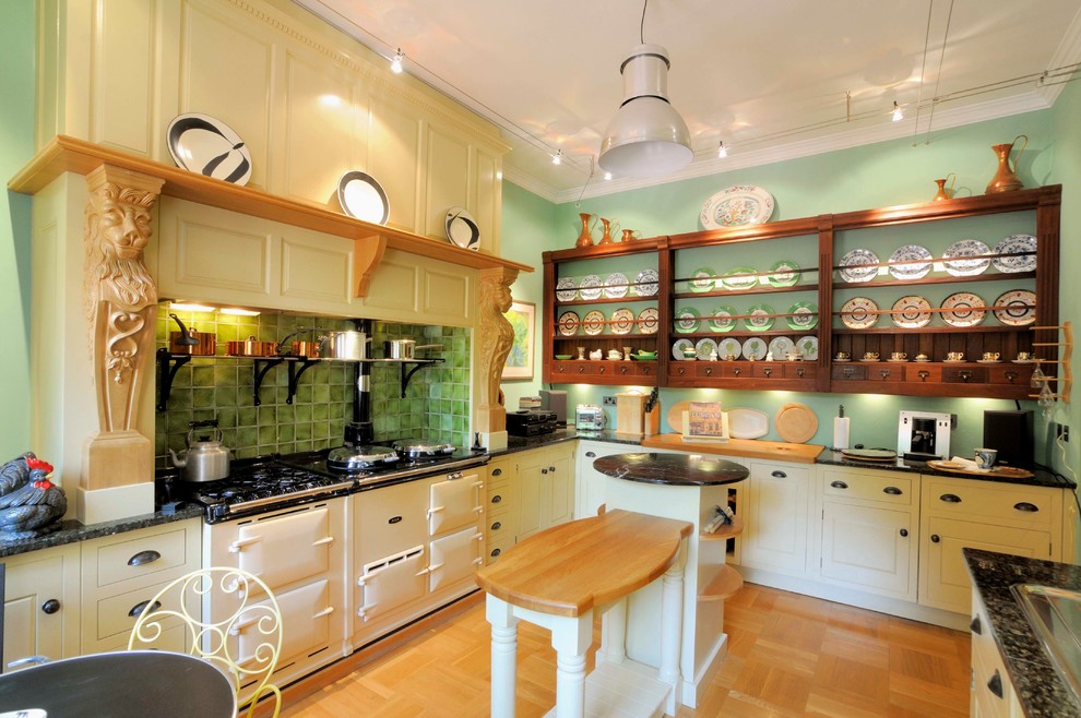 Photo of a mid-sized traditional eat-in kitchen in Other with beige cabinets, marble benchtops, green splashback, white appliances, medium hardwood floors and with island.