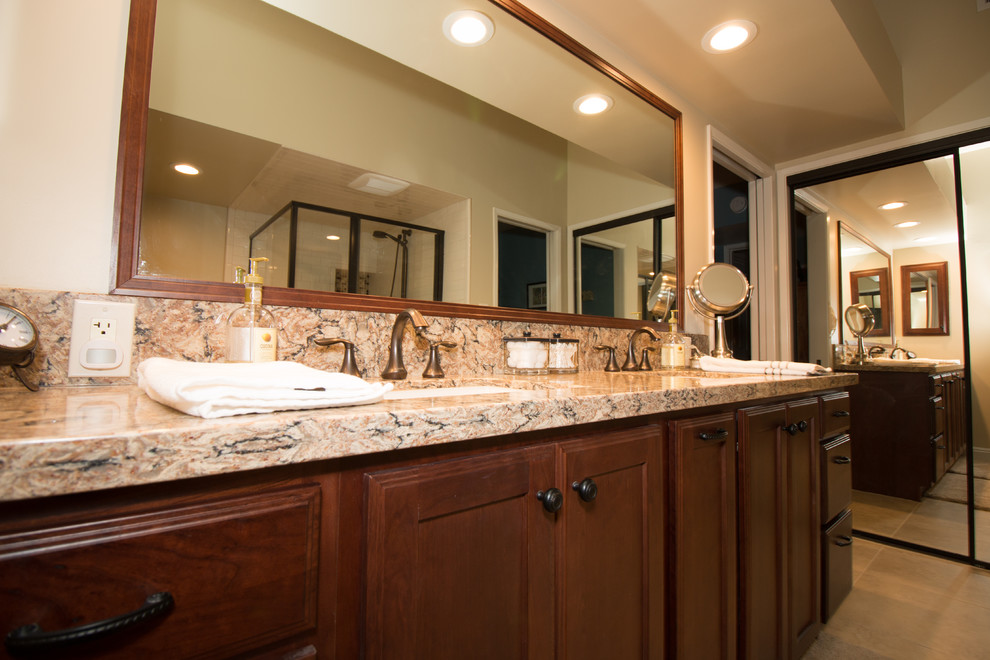 Photo of a mid-sized traditional bathroom in Other with an undermount sink, flat-panel cabinets, medium wood cabinets, engineered quartz benchtops, a drop-in tub, beige tile, subway tile, beige walls and porcelain floors.