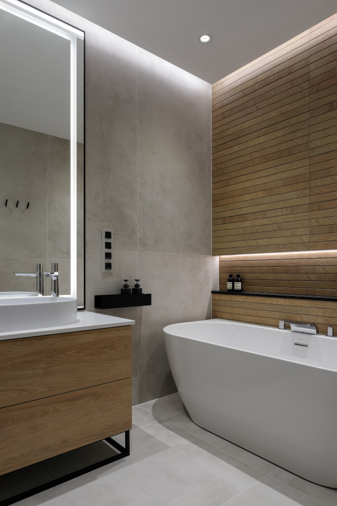Design ideas for a medium sized contemporary ensuite bathroom in Saint Petersburg with flat-panel cabinets, light wood cabinets, a freestanding bath, a wall mounted toilet, beige tiles, porcelain tiles, beige walls, porcelain flooring, a built-in sink, solid surface worktops, grey floors, white worktops, a single sink, a freestanding vanity unit and a drop ceiling.