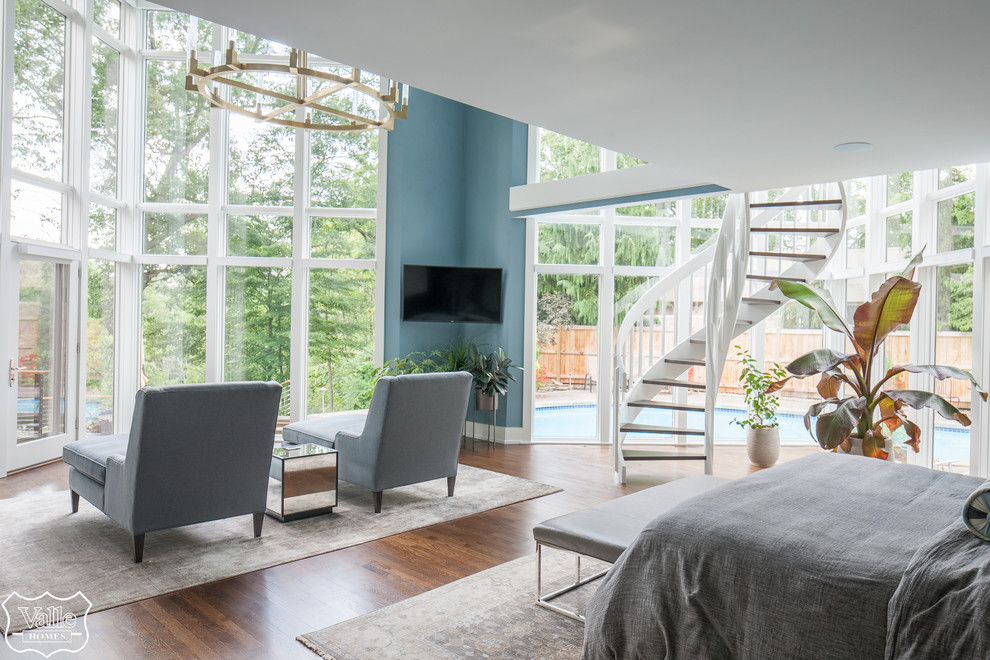 Bedroom - huge transitional master medium tone wood floor and brown floor bedroom idea with blue walls, a two-sided fireplace and a tile fireplace