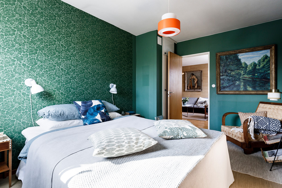 This is an example of a mid-sized midcentury master bedroom in Stockholm with green walls and beige floor.