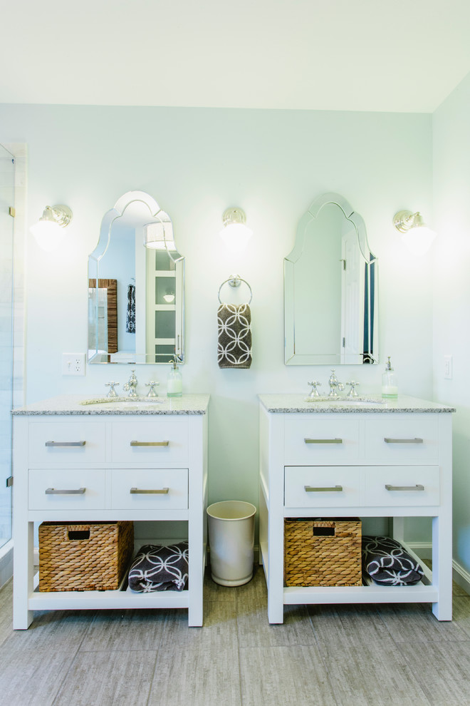This is an example of a traditional bathroom in Nashville with an undermount sink, white cabinets and flat-panel cabinets.