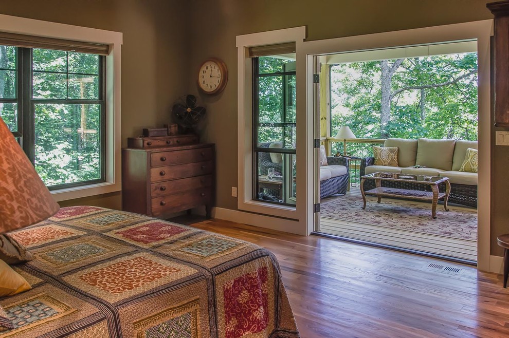 Mid-sized transitional master medium tone wood floor and brown floor bedroom photo with green walls